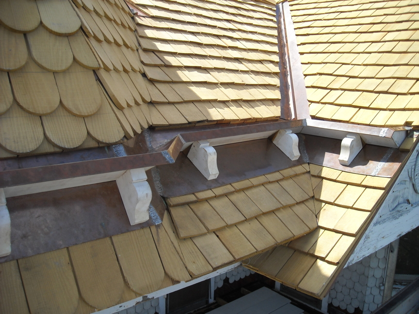 Copper clad stop gutter and channel flashing with new shingles.