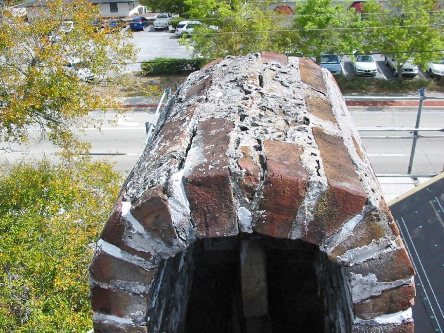 North side chimney deteriorated mortar on dome cap. North side chimney deteriorated mortar on dome cap.