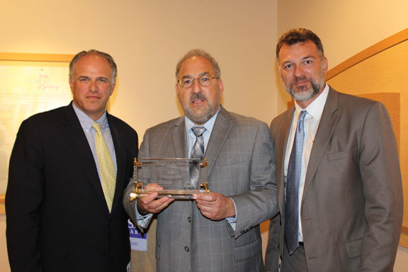 George Mikitarian presents to Joseph Zumpano and Leon Patricios. George Mikitarian presents to Joseph Zumpano and Leon Patricios.